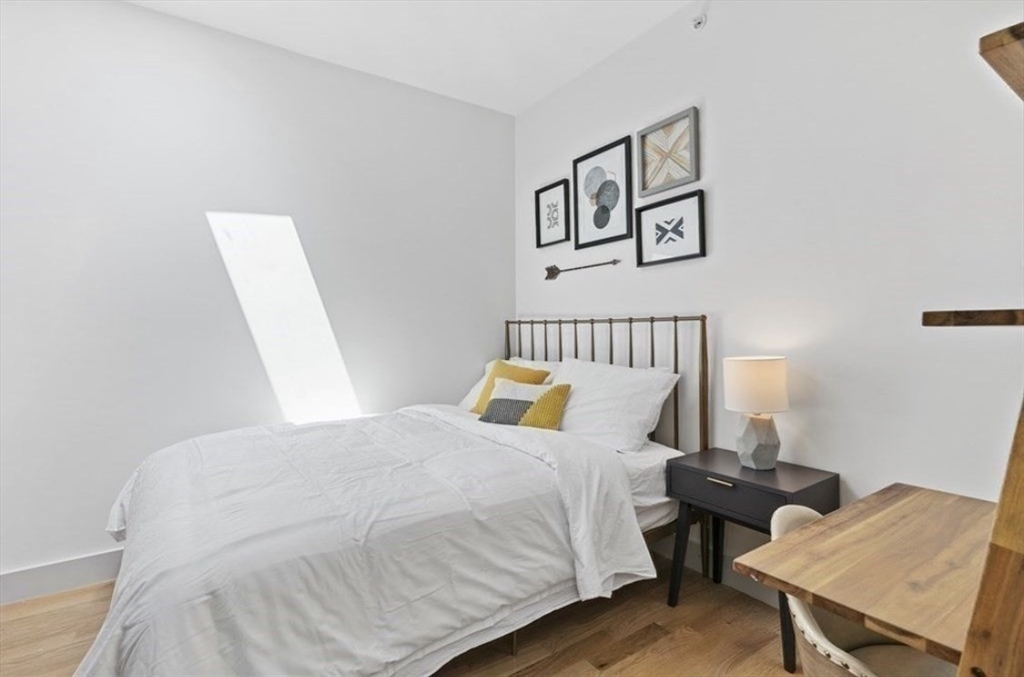 43 Wordsworth Street, Unit 1 Boston, MA 02128 - Photo 15 of 19 a bedroom with a bed and wooden floor