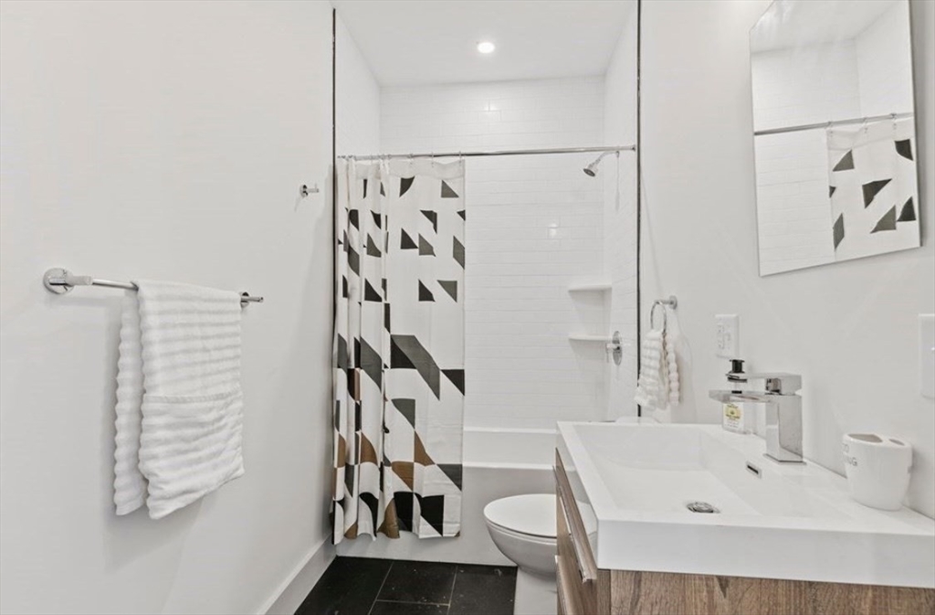 43 Wordsworth Street, Unit 1 Boston, MA 02128 - Photo 17 of 19 a bathroom with a bathtub and shower