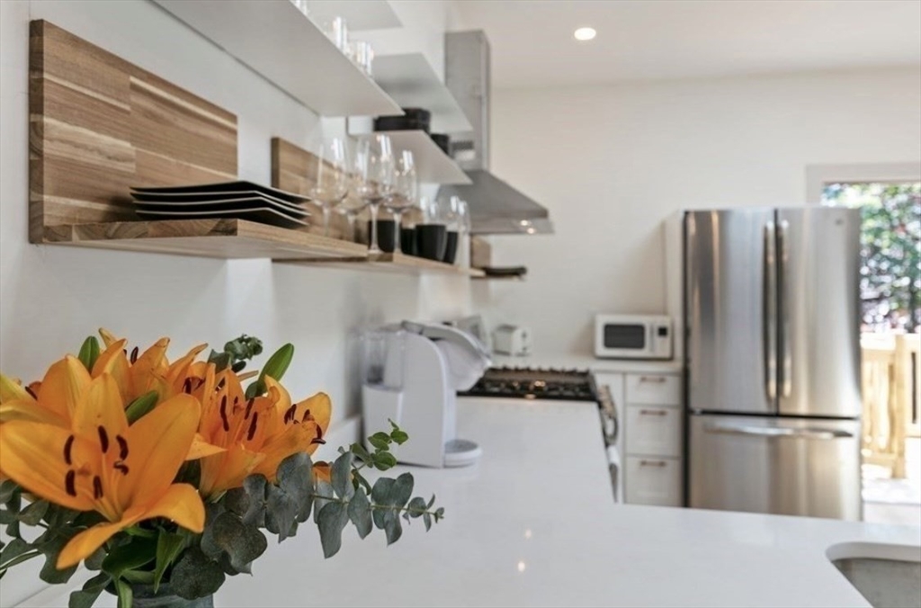 43 Wordsworth Street, Unit 1 Boston, MA 02128 - Photo 2 of 19 a kitchen with stainless steel appliances granite countertop a refrigerator a stove a sink dishwasher and a microwave with wooden floor