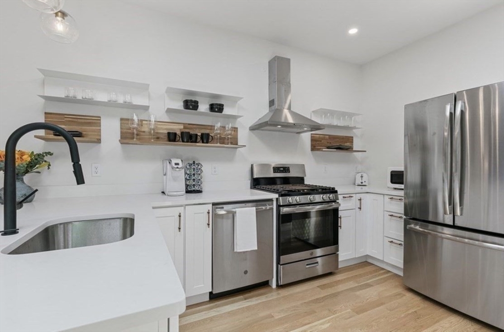 43 Wordsworth Street, Unit 1 Boston, MA 02128 - Photo 4 of 19 a kitchen with stainless steel appliances a sink a stove and a refrigerator