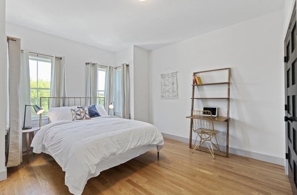 43 Wordsworth Street, Unit 1 Boston, MA 02128 - Photo 10 of 19 a bedroom with a bed a table and painting on the wall