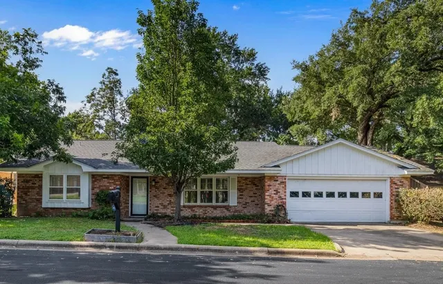 a view of a house with a garden and pathway