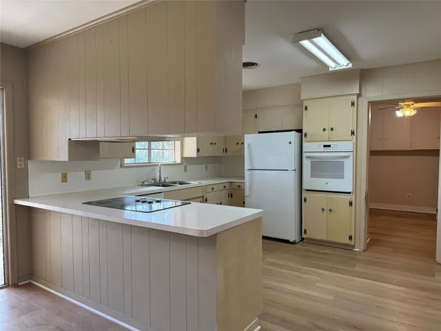 a kitchen with a refrigerator a sink and a stove