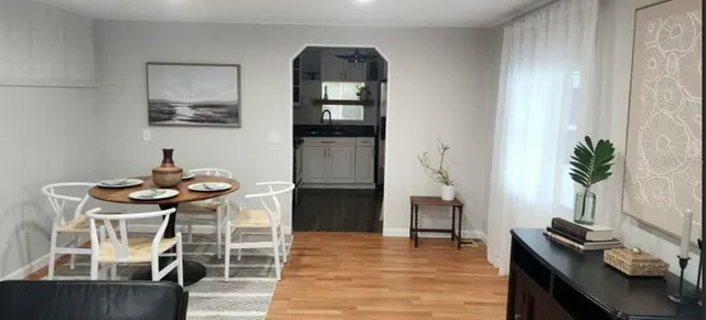 a dining room with furniture and window
