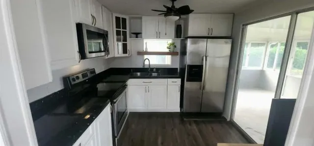 a kitchen with a refrigerator and a sink