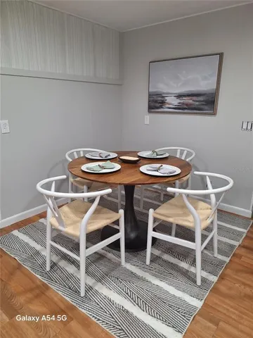 a view of a dining room with furniture and wooden floor
