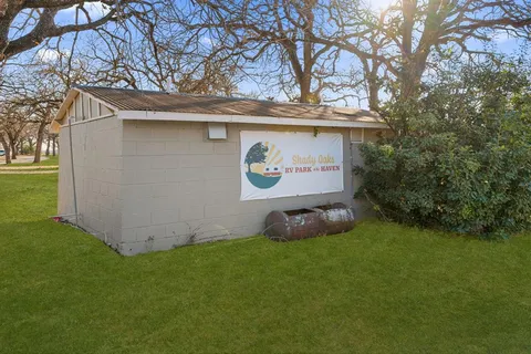 a view of a park with large trees