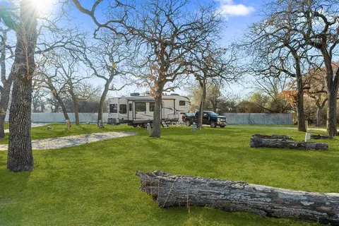 a view of a park with large trees
