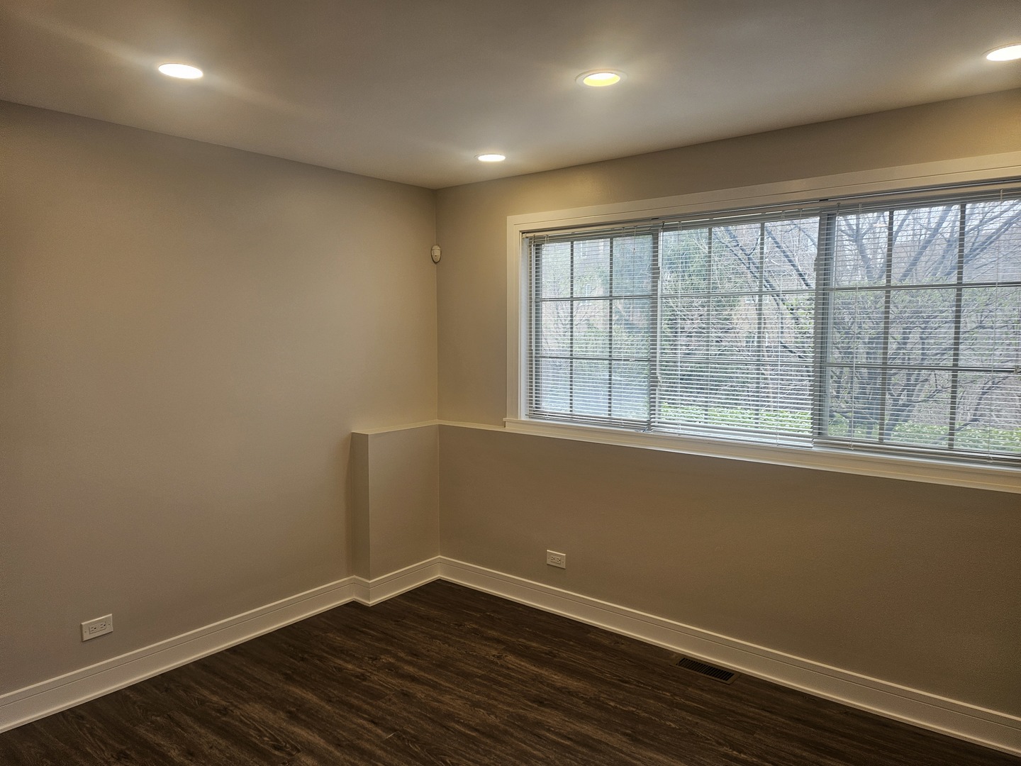 447 Prestwick Lane Wheeling, IL 60090 - Photo 14 of 17 an empty room with wooden floor and windows