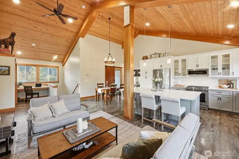 a living room with lots of furniture and kitchen view