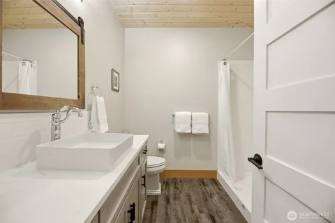 a bathroom with a sink a toilet and a mirror