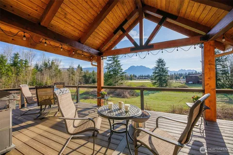 a view of a chairs and table in the balcony