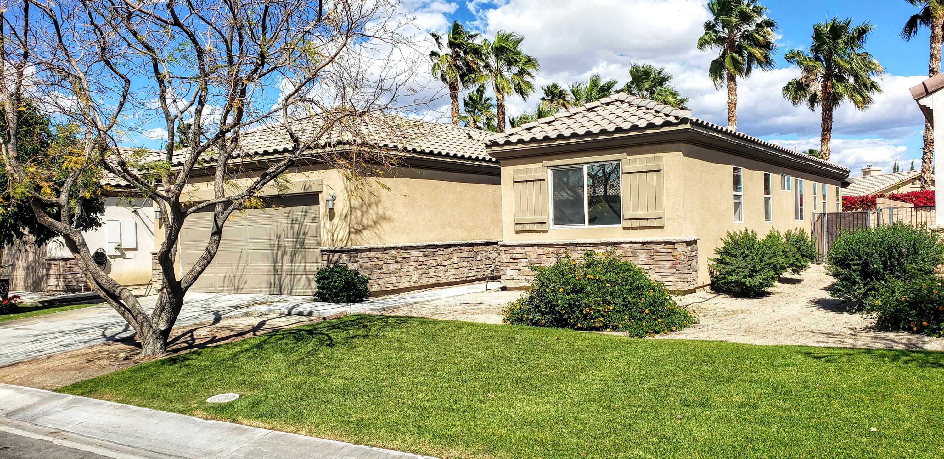 49818 Minelli Street Indio, CA 92201 - Photo 11 of 11 a front view of a house with a yard
