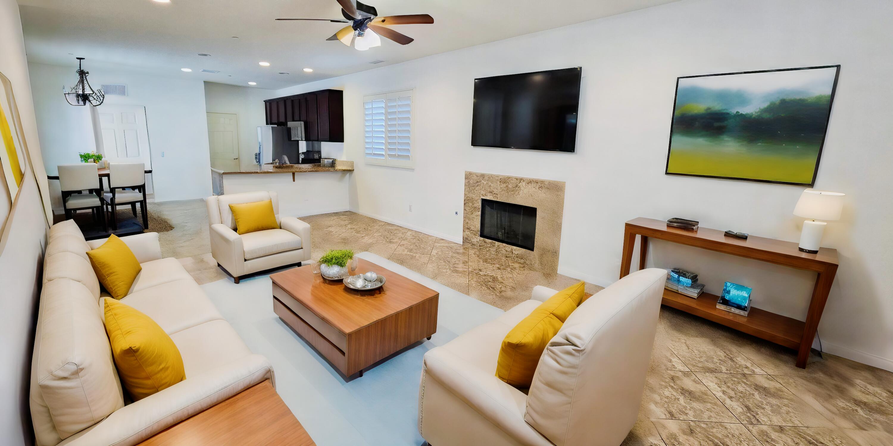 49818 Minelli Street Indio, CA 92201 - Photo 2 of 11 a living room with furniture fireplace and a flat screen tv