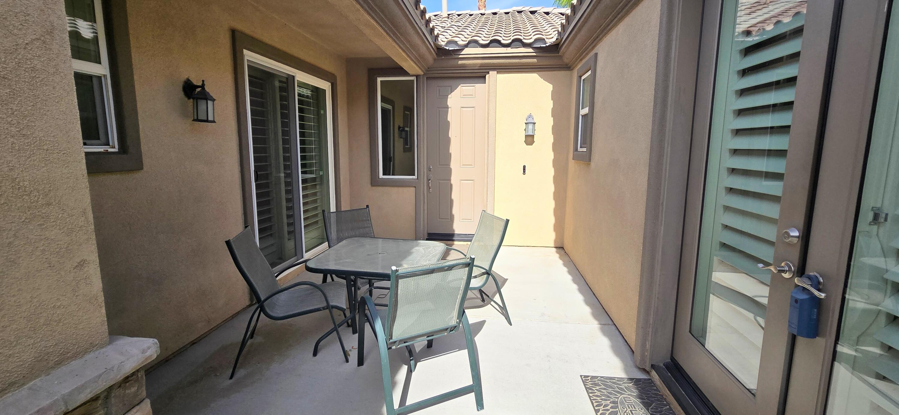 49818 Minelli Street Indio, CA 92201 - Photo 7 of 11 a view of a dining room with furniture and a window