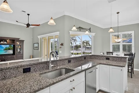 a kitchen with granite countertop a sink and a window