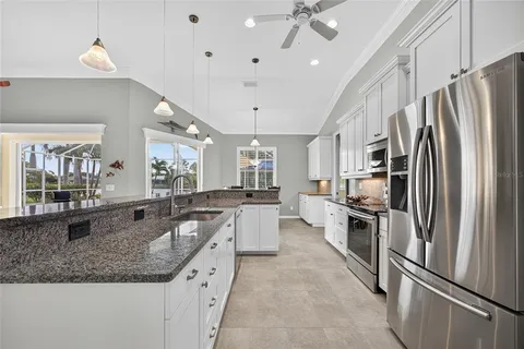a large kitchen with a large counter top appliances and cabinets