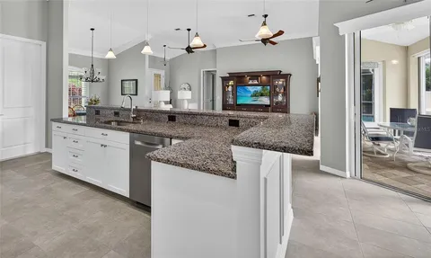 a kitchen with granite countertop a sink and a stove