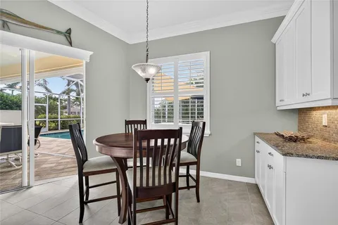 a dining room with furniture a chandelier and window