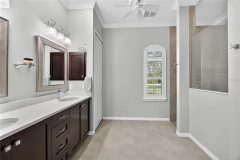 a spacious bathroom with a double vanity sink and a mirror