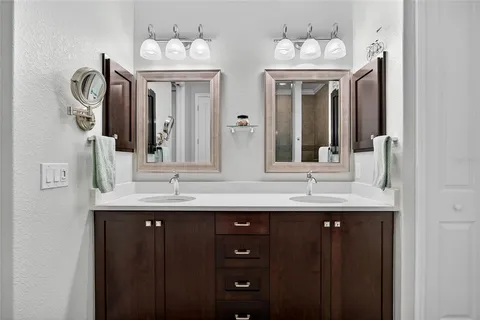 a bathroom with a double vanity sink and a mirror
