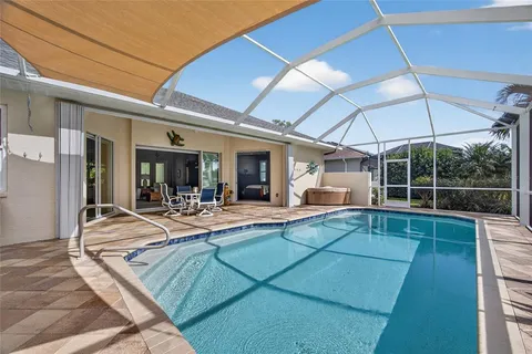 a view of a house with swimming pool and sitting area