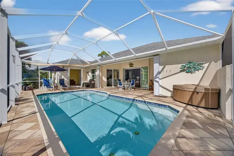 a view of a patio with a table and chairs under an umbrella