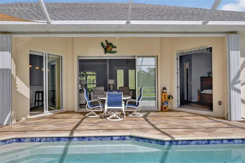 a view of a patio with table and chairs under an umbrella