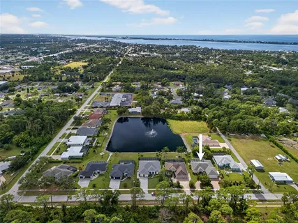 an aerial view of residential houses with outdoor space and river