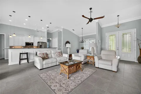 a living room with furniture and kitchen view