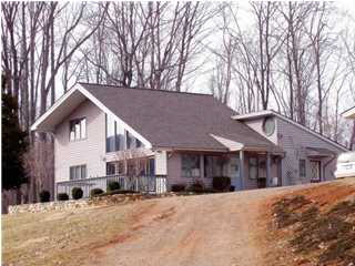 514 Rainbow Ridge Road Faber, VA 22938 - Photo 1 of 8 a view of a house with a yard covered in snow