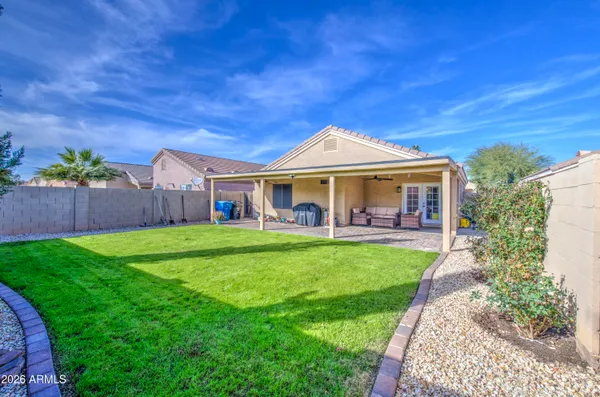 a view of an house with backyard space and balcony