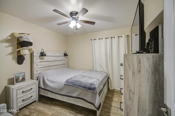 a bedroom with a bed and a chandelier