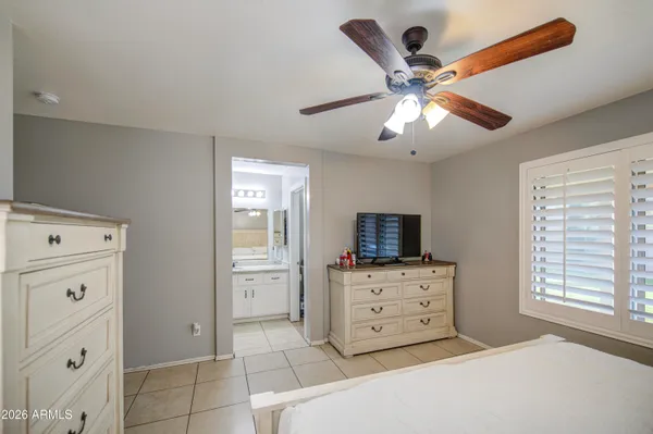 a bedroom with a bed and a television