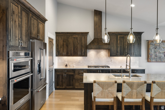 1737 East Viewside Circle Hideout, UT 84036 - Photo 7 of 35 Kitchen featuring dark wood-finish cabinetry, stainless steel double ovens, and a matching refrigerator