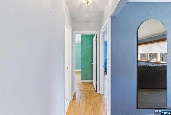 a bedroom with a bed and painting on the wall