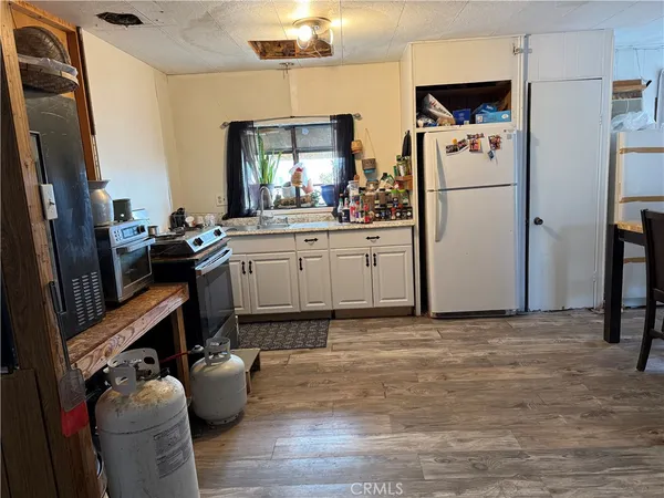 a kitchen with refrigerator and cabinets