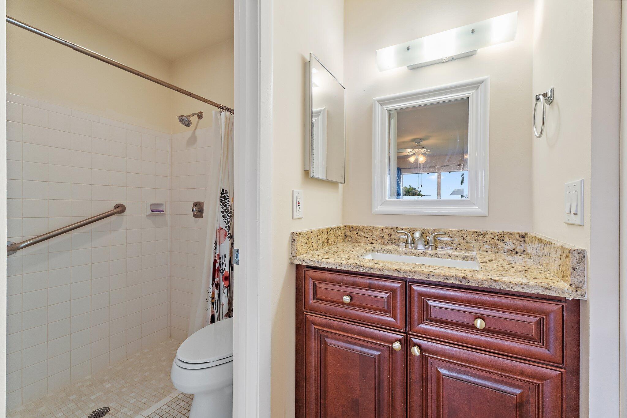 109 Doe Trail Jupiter, FL 33458 - Photo 14 of 26 a bathroom with a granite countertop sink toilet and shower