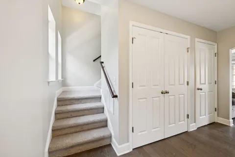 a view of a hallway with wooden floor and entryway