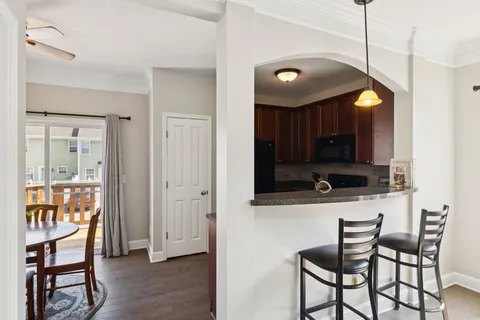 a view of a room with a dining table and chairs