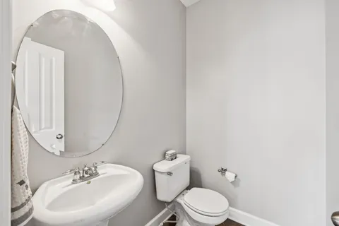 a white toilet sitting next to a white sink