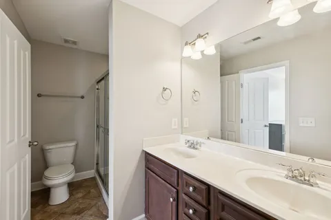 a bathroom with a sink toilet and shower