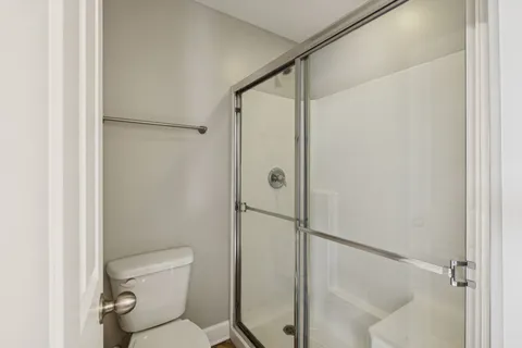 a bathroom with a shower and toilet