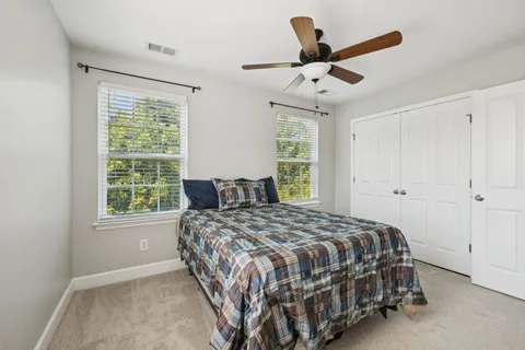 a bedroom with a bed and window
