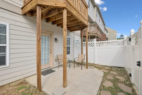 a view of a porch with a table and chairs