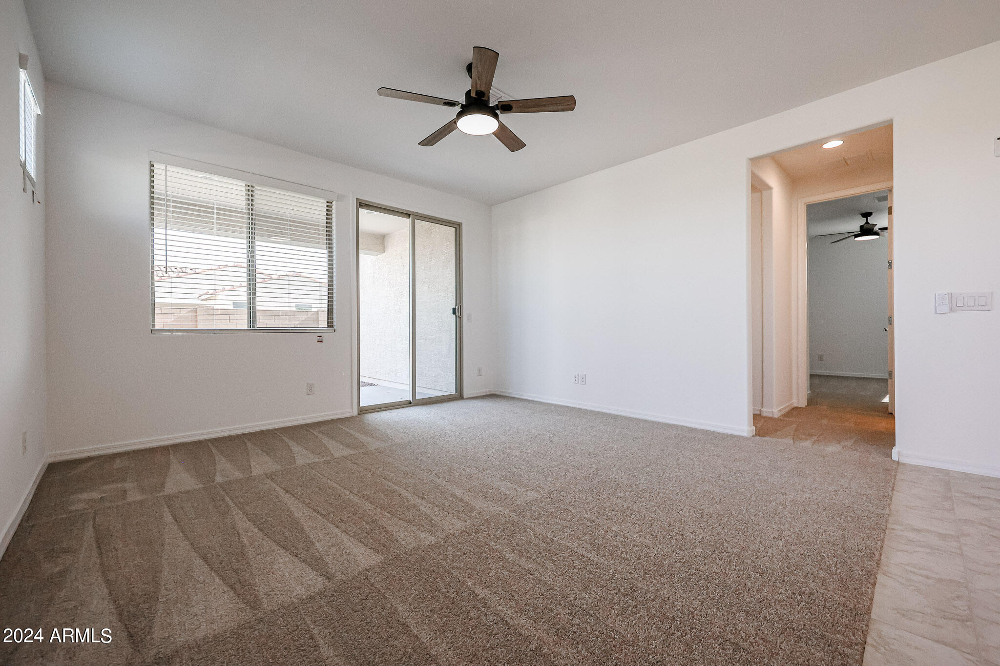 8907 West Colter Street Glendale, AZ 85305 - Photo 12 of 44 an empty room with ceiling fan and window