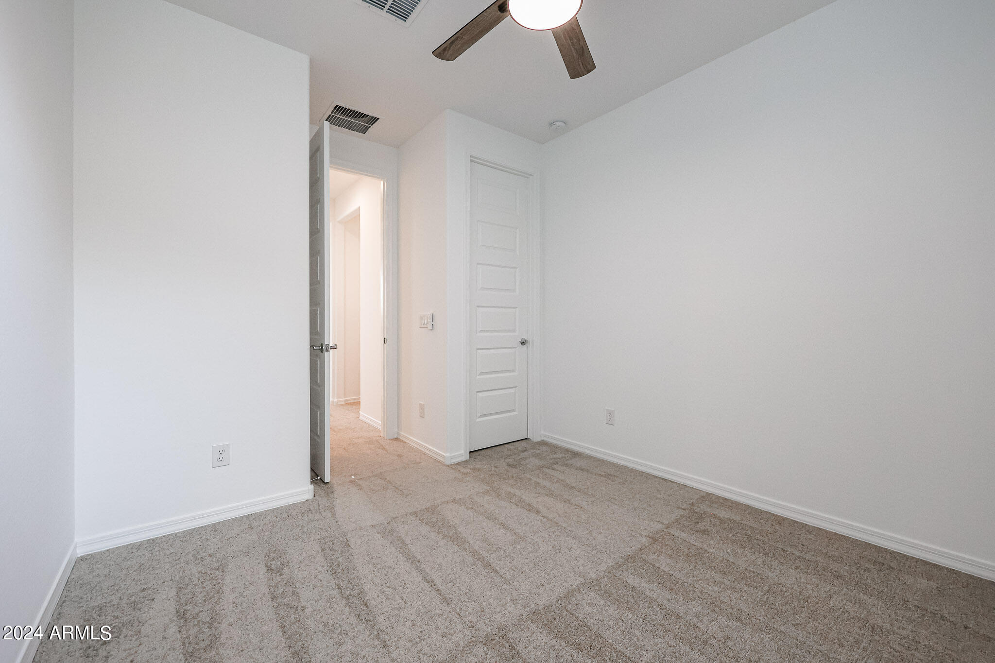 8907 West Colter Street Glendale, AZ 85305 - Photo 27 of 44 an empty room with closet and a chandelier fan