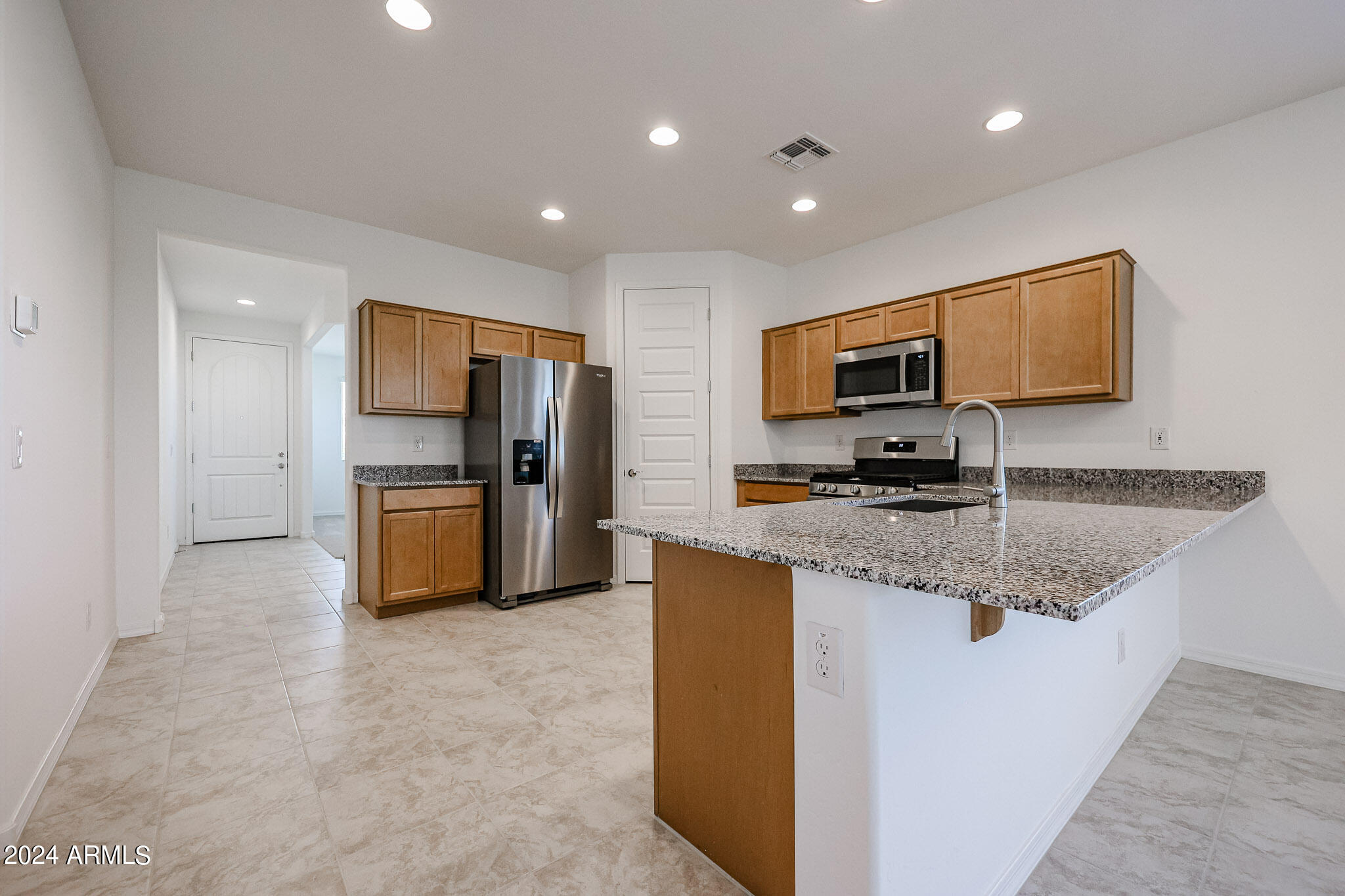 8907 West Colter Street Glendale, AZ 85305 - Photo 3 of 44 a kitchen with refrigerator and microwave