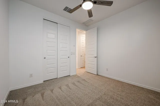an empty room with a ceiling fan