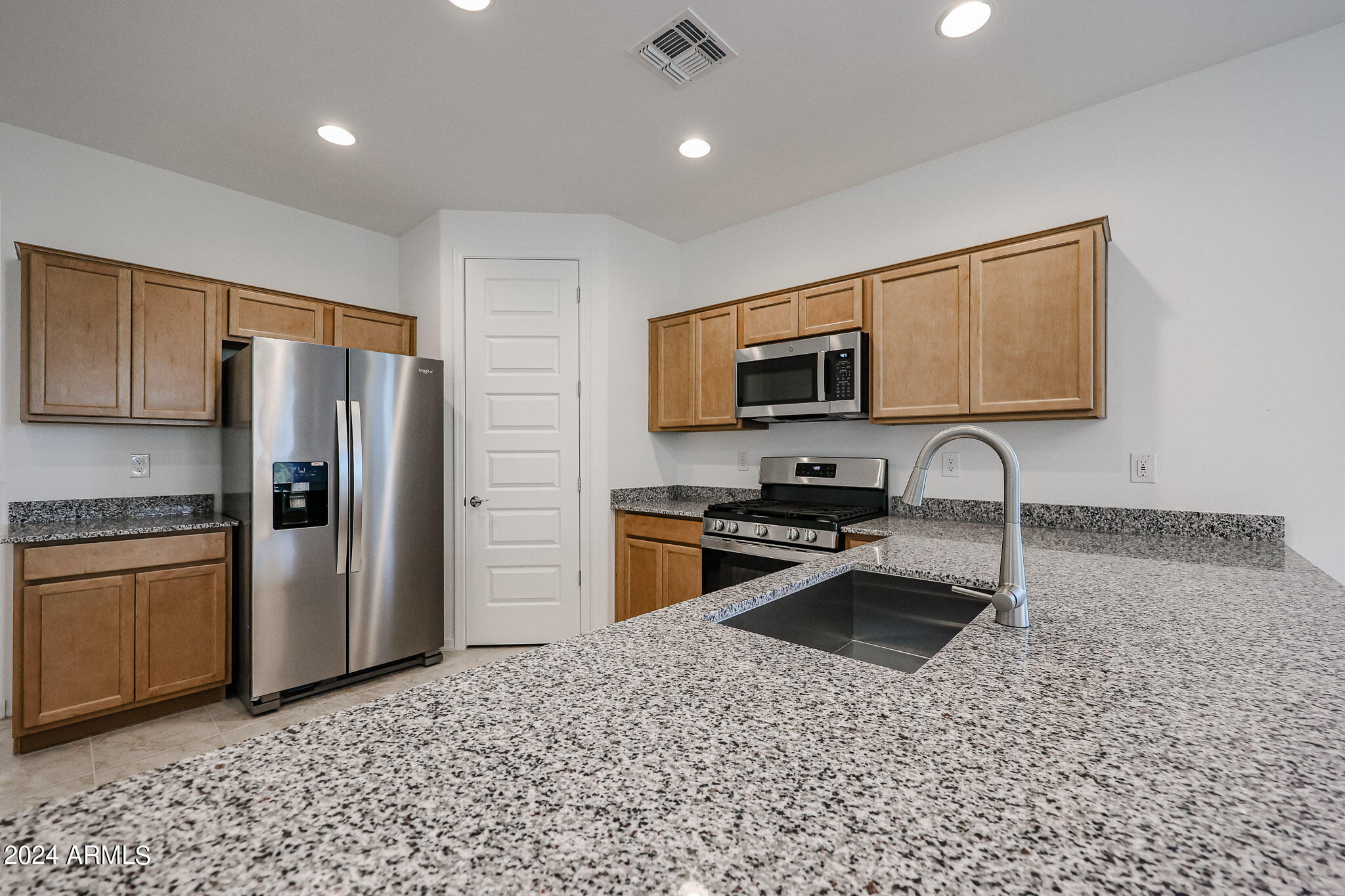 8907 West Colter Street Glendale, AZ 85305 - Photo 4 of 44 a kitchen with stainless steel appliances granite countertop a refrigerator a stove a sink a microwave a sink and dishwasher